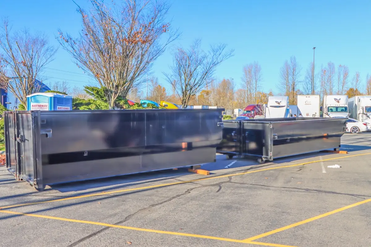 Professional dumpster rental service with roll-off container on residential driveway in Broadview